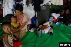 A family who fled violence in a Rakhine state village is seen at a camp for internally displaced persons in Sittwe, Myanmar, Sept. 1, 2017.
