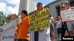 FILE - Faculty and staff at the University of Texas protest against a state law that allows for guns in classrooms at college campuses, in Austin, Texas, Aug. 24, 2016.