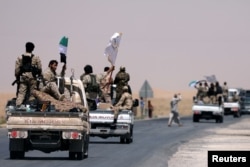 FILE - Syrian Democratic Forces (SDF) fighters head to Raqqa, Syria, June 6, 2017.