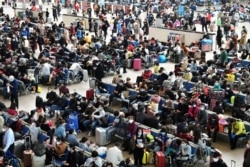 Travellers are seen inside Hankou Railway Station after travel restrictions to leave Wuhan, the capital of Hubei province and China's epicentre of the novel coronavirus disease (COVID-19) outbreak, were lifted, April 8, 2020. (REUTERS)