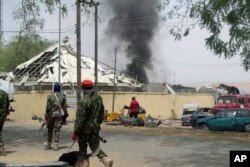 Nigerian soldiers patrol outside the site of an accidental explosion of Boko Haram bombs in Yola, Nigeria, Feb. 25, 2016.