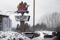 FILE - A sign seeking workers is displayed at a fast food restaurant in Portland, Oregon, Dec. 27, 2021.