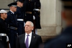 Defense Secretary Jim Mattis stands as he waits for Netherlands Minister of Defense Jeanine Hennis-Plasschaert during an enhanced honor cordon at the Pentagon, Aug. 15, 2017, in Washington.