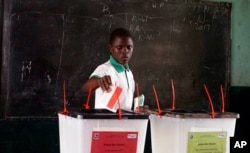 A man cast his vote during the first round of presidential elections in Monrovia, Liberia, Oct. 10, 2017. A run-off vote, originally scheduled for Nov. 7, has now been postponed.