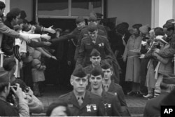Kevin Hermening, second from front, was among the Marines held hostage in Iran. On their way home, they’re shown leaving Wiesbaden Air Force hospital Jan. 25, 1981.