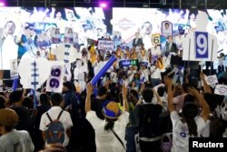 Supporters and candidates celebrate during the Palang Pracharath Party's party campaign rally in central Bangkok, Thailand, March 22, 2019.