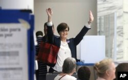 Leah Schier throws up her arms after casting her ballot in Dallas, Nov. 8, 2016. "I was so exited to cast my vote for a woman," she said.