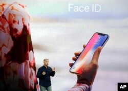 In this Tuesday, Sept. 12, 2017, file photo, Phil Schiller, Apple's senior vice president of worldwide marketing, announces features of the new iPhone X, including Face ID, at the new Apple campus in Cupertino, Calif. (AP Photo/Marcio Jose Sanchez, File)