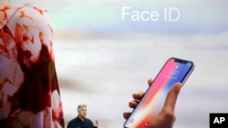 In this Tuesday, Sept. 12, 2017, file photo, Phil Schiller, Apple's senior vice president of worldwide marketing, announces features of the new iPhone X, including Face ID, at the new Apple campus in Cupertino, Calif. (AP Photo/Marcio Jose Sanchez, File)