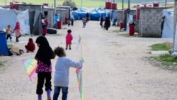 Children of foreign fighters play in the al-Roj camp in Syria, March 1, 2019. (H. Murdock/VOA)