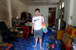 General Secretary of Free Youth group Tattep Ruangprakitseree stands inside his house in Bangkok, Thailand August 28, 2020. Picture taken August 28, 2020. REUTERS/Jiraporn Kuhakan