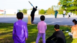 Afghan refugees play in an informal cricket match at Fort McCoy, Wisc., Sept. 29, 2021. The fort is one of several places in the US where Afghans receive temporary housing, medical screening, and general support following evacuation from Afghanistan.