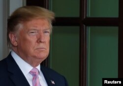 FILE - U.S. President Donald Trump waits to welcome Egypt's President Abdel-Fattah el-Sissi to the White House in Washington, April 9, 2019.