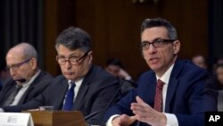 FILE - Clinton Watts, right, a Senior Fellow at the Foreign Policy Research Institute Program on National Security, testifies before the Senate Intelligence Committee hearing on Capitol Hill in Washington, March 30, 2017, on Russian intelligence activities.