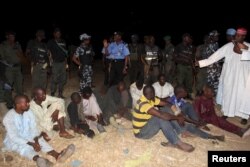 Polisi jimbo la Kano wakiwaweka washukiwa wa wizi wa ng'ombe chini ya ulinzi katika kijiji cha Dajin Gomo village of Sumaila eneo la Kano, Nigeria, Novemba 2, 2015.