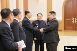North Korean leader Kim Jong Un meets members of the high-level delegation of the Democratic People's Republic of Korea, which visited South Korea to attend the opening ceremony of the 23rd Winter Olympics.