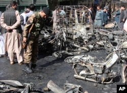 Afghan security forces inspect the site of a blast in Herat, Afghanistan, June 6, 2017.