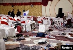 Afghan security forces investigate at the site of a suicide bomb attack the day before in Kabul, Afghanistan, Nov. 21, 2018.