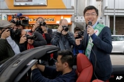 Hong Kong pro-democracy by-election candidate Au Nok-hin, right, speaks during an election campaign in Hong Kong, March 11, 2018.