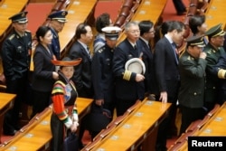 Delegates leave the hall after the second plenary session of the National People's Congress (NPC) at the Great Hall of the People in Beijing, March 8, 2019.