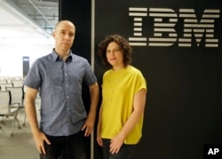 Dr. Noam Slonim, left, principal investigator, and Dr. Ranit Aharonov, right, manager, pose near the IBM Project Debater before a debate between the computer and two human debaters in San Francisco, June 18, 2018.