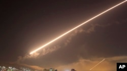Damascus skies erupt with surface to air missile fire as the U.S. launches an attack on Syria targeting different parts of the Syrian capital Damascus, Syria, early Saturday, April 14, 2018.