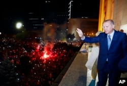 Turkish President Recep Tayyip Erdogan waves to supporters of his ruling Justice and Development Party (AKP) in Ankara, Turkey, early Monday, June 25, 2018, having won Turkey's landmark election Sunday.