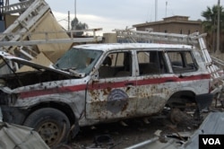 IS militants leave a wave of destruction as they are beaten back by Iraqi and coalition forces, including this IS police car, stolen from Iraqi police and relabeled as Islamic State, in Mosul, Iraq, March 23, 2017. (H.Murdock/VOA)