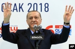Turkey's President Recep Tayyip Erdogan gestures to supporters of his ruling Justice and Development Party at a rally in Bingol, Turkey, Jan. 13, 2018.