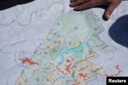 FILE - Managing Partner of CM Mining Dale Murray explains property leases on an active coal mine located next to a new solar power plant development site in Hurley, western Virginia, May 11, 2021.