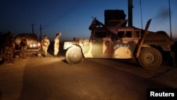 Afghan security forces keep watch at the site of an attack and gun fire between insurgents and Afghan forces in Kabul, Afghanistan Sept. 27, 2017.