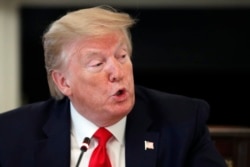 President Donald Trump speaks about reopening the country, during a roundtable with industry executives, in the State Dinning Room of the White House, April 29, 2020, in Washington.