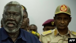 Le général Mohamed Hamdan Daglo (d) écoute Malik Agar (g) le chef du Mouvement populaire de libération du Soudan-Nord, alors chef adjoint soudanais du Conseil militaire de transition, à Juba, au Soudan du Sud, le 27 juillet 2019. 