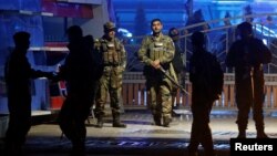 Afghan security forces arrive at the site of a suicide bomb attack in Kabul, Afghanistan, Nov. 20, 2018. 