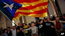 Catalan independence supporters wave a 'estelada' ( pro-independence Catalan flag ) celebrate at the ANC ( Catalan National Assembly ) headquarters after results of the regional elections in Barcelona, Spain, Thursday, Dec. 21, 2017. (AP Photo/Emilio Morenatti)