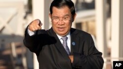 Cambodia's Prime Minister Hun Sen gestures as he arrives for a group photo of leaders at the 11th Asia-Europe Meeting (ASEM) in Ulaanbaatar, Mongolia, Saturday, July 16, 2016. (AP Photo/Mark Schiefelbein)