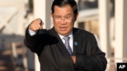 Cambodia's Prime Minister Hun Sen gestures as he arrives for a group photo of leaders at the 11th Asia-Europe Meeting (ASEM) in Ulaanbaatar, Mongolia, Saturday, July 16, 2016. (AP Photo/Mark Schiefelbein)