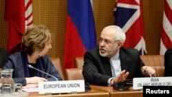European Union Foreign Policy Chief Catherine Ashton, left, speaks with Iranian Foreign Minister Mohammad Javad Zarif before talks begin in Vienna.