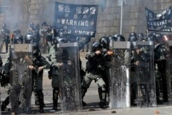 Police prepare to fire on protestors at the Hong Kong Polytechnic University in Hong Kong, Nov. 17, 2019.