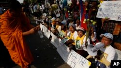 In this photo taken on Jan. 22, 2015, villagers from the Boeung Kak lake community shout slogans during a protest rally in front of Appeals Court in Phnom Penh, Cambodia. 