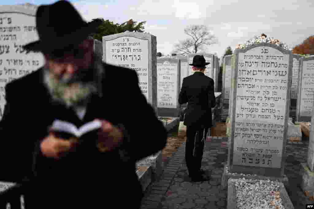 Chabad-Lubavitch rabbis gather in prayer at the resting place of the Rebbe Menachem M. Schneerson in the Old Montefiore Cemetery in the Queens borough of New York City.