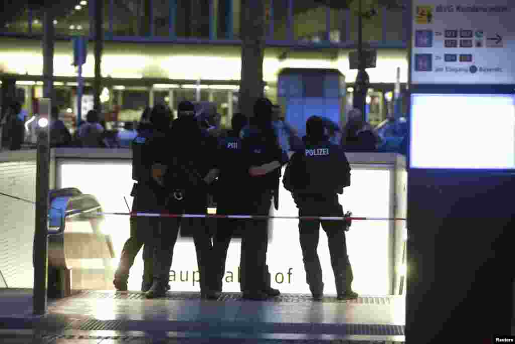 Special force police officers stand guard at an entrance of the main train station, following a shooting rampage at the Olympia shopping mall in Munich, Germany, July 22, 2016. 
