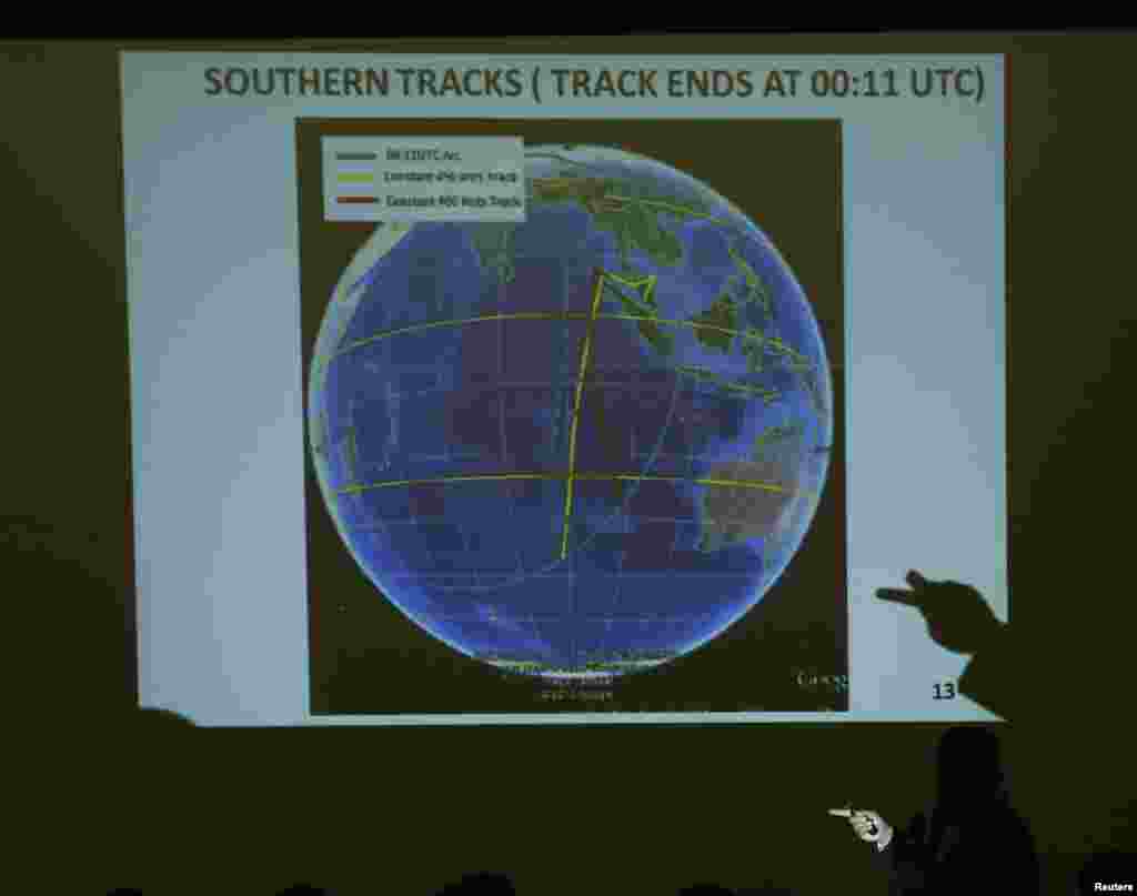 Letnan Jenderal Malaysia Ackbal Samad menunjukkan peta kemungkinan rute penerbangan MH370 pada keluarga penumpang dalam sebuah briefing yang diadakan oleh pemerintah Malaysia di Lido Hotel di Beijing, 26 Maret 2014.