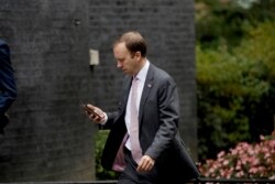 British Health Secretary Matt Hancock walks through Downing Street on his way into number 10, in London, Sept. 23, 2020.