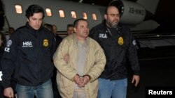 FILE - Mexico's top drug lord Joaquin "El Chapo" Guzman is escorted as he arrives at Long Island MacArthur airport in New York, Jan. 19, 2017, following his extradition from Mexico.