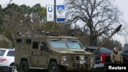 An armored law enforcement vehicle is seen in the area where a man has reportedly taken people hostage at a synagogue during services that were being streamed live, in Colleyville, Texas, Jan. 15, 2022. 