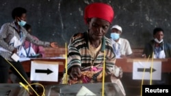 FILE - A voter casts her ballot in Ngozi, Burundi, May 20, 2020, amid concerns over political violence and COVID-19 infection.