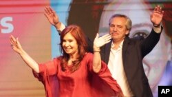 Peronist presidential candidate Alberto Fernández, behind, and running mate, former President Cristina Fernández, celebrate after the election results in Buenos Aires, Argentina, Oct. 27, 2019.