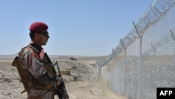 A Pakistani army soldier stands guard along with border fence at the Pakistan-Afghanistan border near the Punjpai area of Quetta in Balochistan on May 8, 2018.