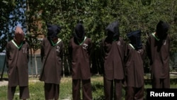 FILE - Insurgents suspected of being from the Haqqani network are presented to the media at the National Directorate of Security (NDS) headquarters in Kabul May 30, 2013.